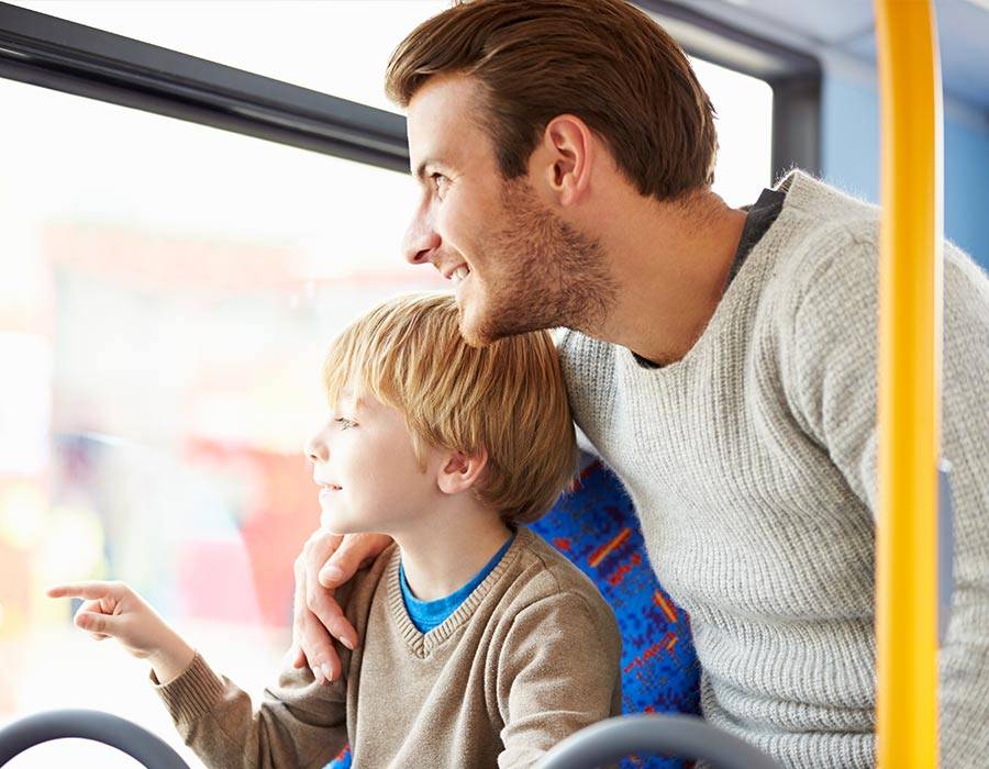 Man and son looking out of a window on a Shawnee Mass Transit bus ride